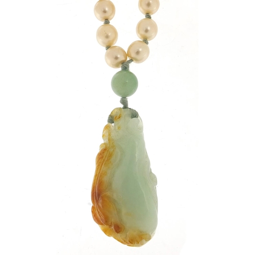 2559 - Chinese jade pendant carved with a dragon on a jade and simulated pearl necklace, 5cm high and 7.0cm... 