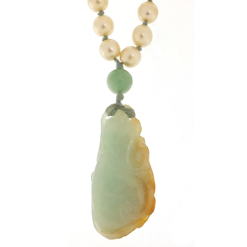 2559 - Chinese jade pendant carved with a dragon on a jade and simulated pearl necklace, 5cm high and 7.0cm... 