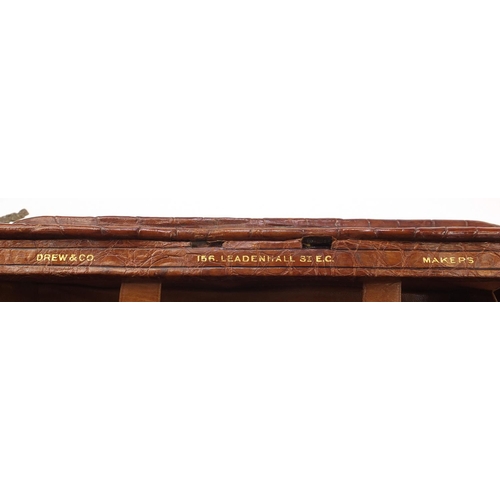 139 - Drew & Sons, Victorian crocodile skin travelling vanity case with a selection of silver mounted cut ... 