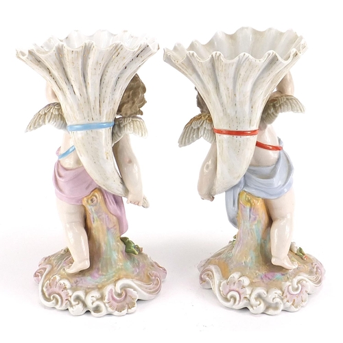 403 - Pair of Continental porcelain Putti and cornucopia design spill vases with floral encrusted bases, e... 