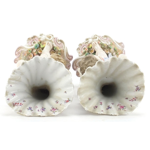 403 - Pair of Continental porcelain Putti and cornucopia design spill vases with floral encrusted bases, e... 