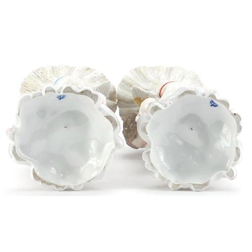 403 - Pair of Continental porcelain Putti and cornucopia design spill vases with floral encrusted bases, e... 