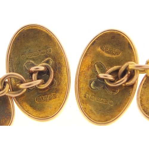 323 - Pair of 9ct gold cufflinks with engine turned decoration housed in a fitted tooled leather box, hall... 