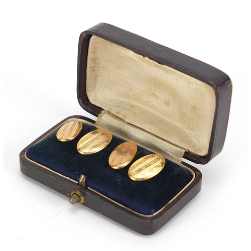 323 - Pair of 9ct gold cufflinks with engine turned decoration housed in a fitted tooled leather box, hall... 