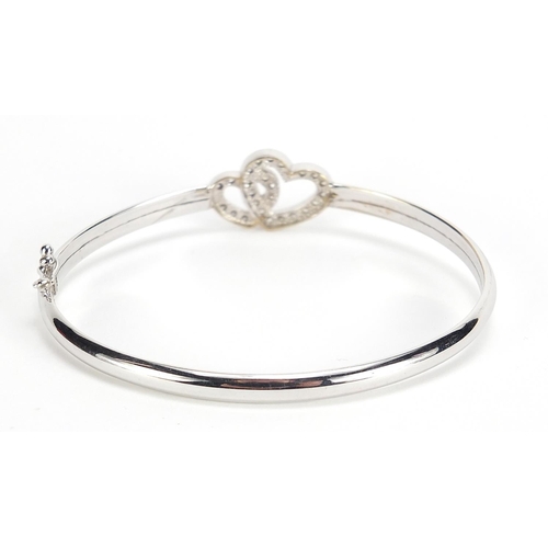 590 - 9ct white gold double love heart bangle set with clear stones, 6.5cm wide, 6.2g