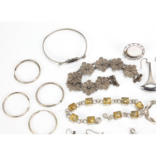 1823 - Silver jewellery including amber coloured necklace, hardstone brooches, bracelets and a pair of thre... 