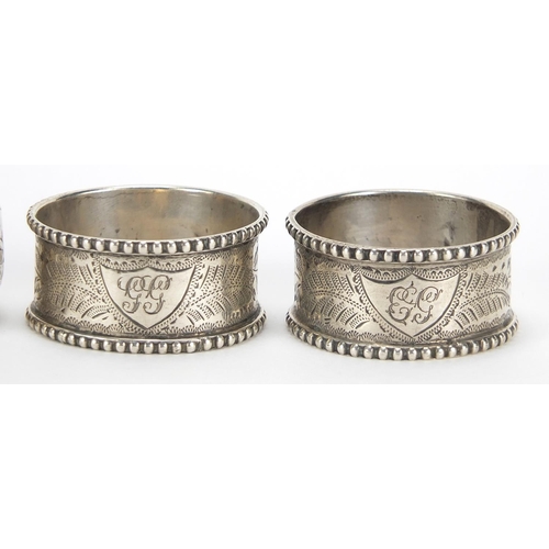 87 - Four Victorian and later silver napkin rings including a pair by Thomas Hayes, Birmingham 1905, the ... 