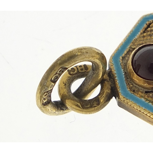 778 - Silver gilt and enamel pendant set with a cabochon garnet, impressed Russian marks, 4cm high, 10.6g