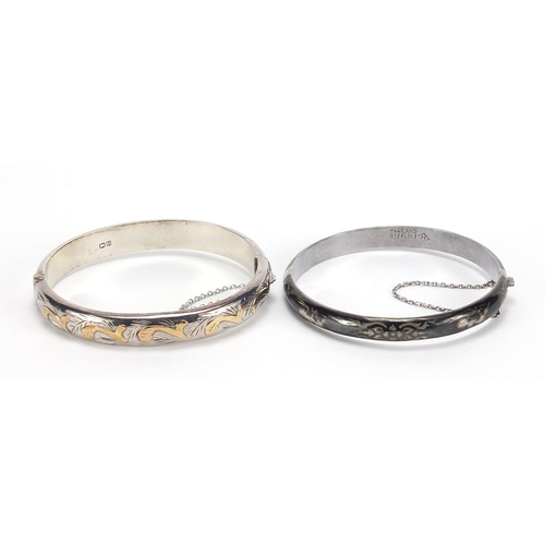 2101 - Two silver hinged bangles including one with Niello work, total 30.2g