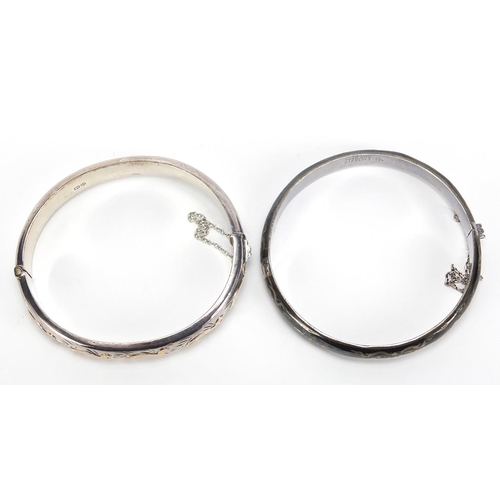 2101 - Two silver hinged bangles including one with Niello work, total 30.2g