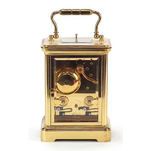 78 - Large brass cased repeating carriage clock striking on a bell with enamelled dial having Roman and A... 