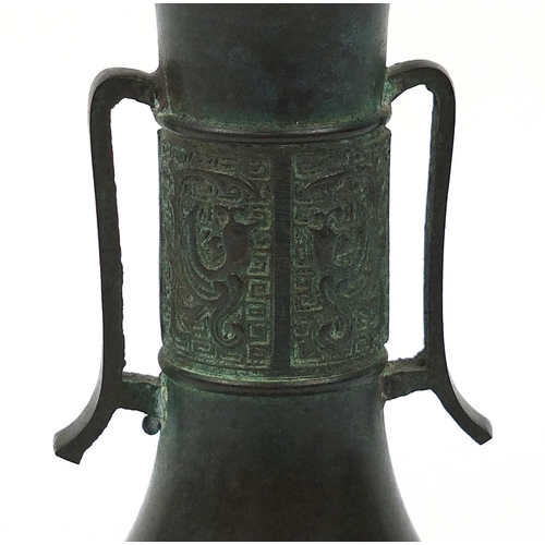 454 - Japanese patinated bronze vase with twin handles, impressed character marks to the base, 21.5cm high