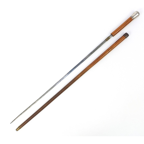 873 - Malacca sword stick with silver pommel and steel blade, 91cm in length