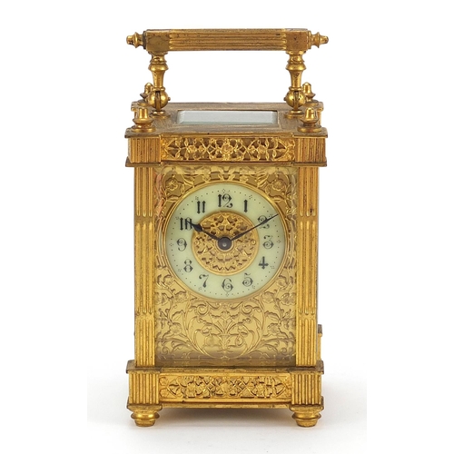 77 - 19th century gilt brass carriage clock with foliate fret panels and enamelled chapter ring having Ar... 