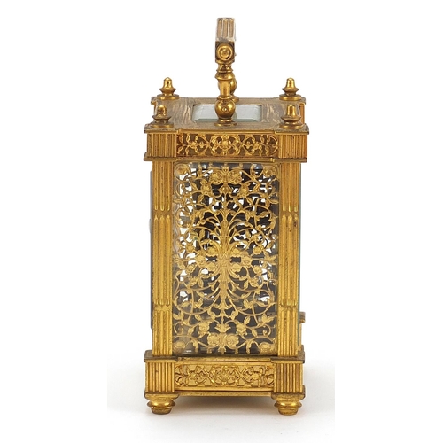 77 - 19th century gilt brass carriage clock with foliate fret panels and enamelled chapter ring having Ar... 