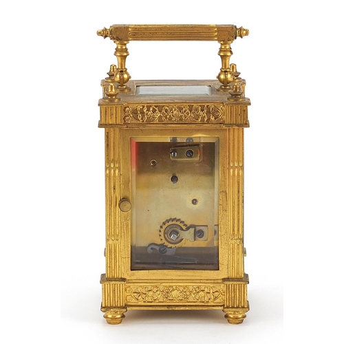 77 - 19th century gilt brass carriage clock with foliate fret panels and enamelled chapter ring having Ar... 