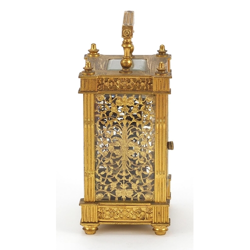 77 - 19th century gilt brass carriage clock with foliate fret panels and enamelled chapter ring having Ar... 