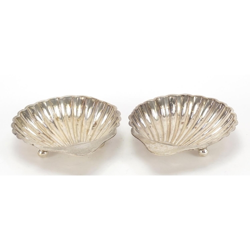 174 - Harrison Brothers & Howson, pair of George V silver shell shaped dishes raised on three ball feet, S... 