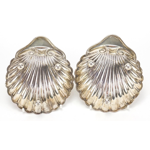 174 - Harrison Brothers & Howson, pair of George V silver shell shaped dishes raised on three ball feet, S... 