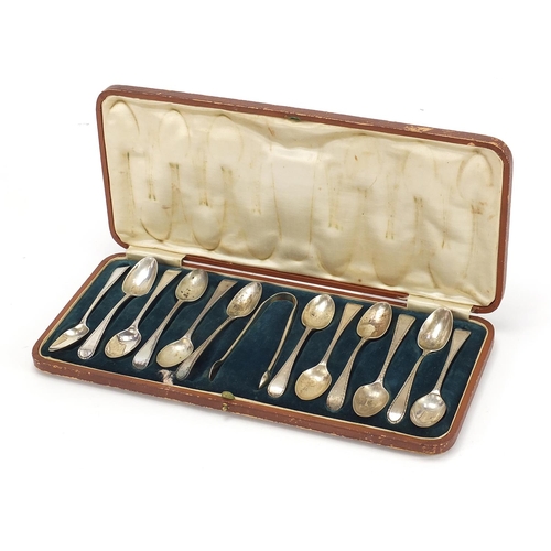 1121 - Matched set of twelve silver teaspoons and silver plated sugar tongs housed in a velvet and silk lin... 