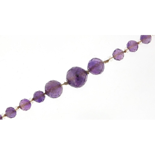 2027 - Vintage graduated amethyst and crystal bead necklace, 80cm in length, 50.2g