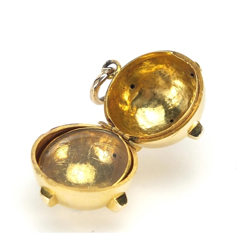 52 - Unmarked gold mine design locket pendant, (tests as 15ct+ gold) 2cm in diameter, 7.2g