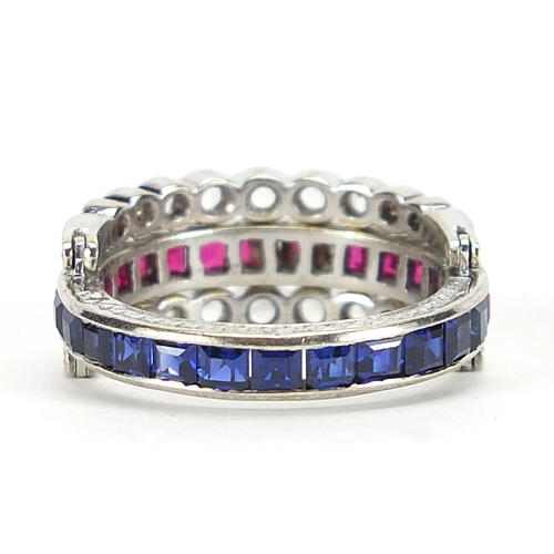 592 - Unmarked white metal triple eternity hinged ring set with rubies, blue sapphires and white sapphires... 