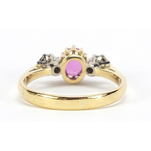 625 - 18ct gold ruby and diamond three stone ring, size Q, 3.7g