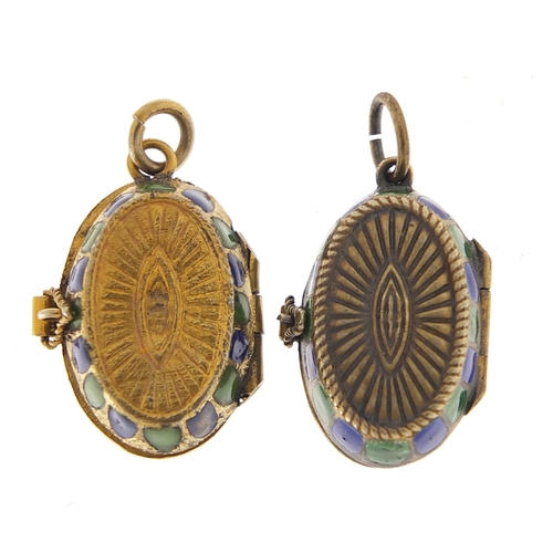 215 - Two Egyptian Revival silver and enamel sarcophagus design pendants with hinged lids, the largest 2cm... 