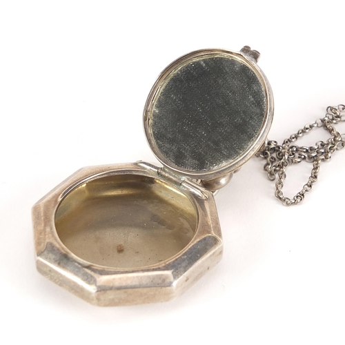 2554 - George V octagonal silver pill box with hinged lid and mirrored interior on a silver Longuard chain,... 