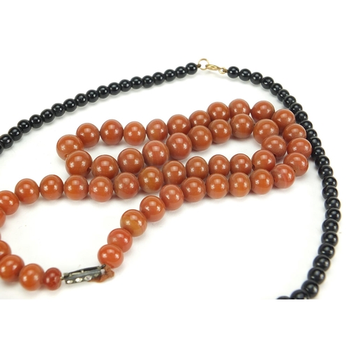 2558 - Four necklaces and an amethyst bracelet with 9ct gold clasp including goldstone and carnelian with s... 