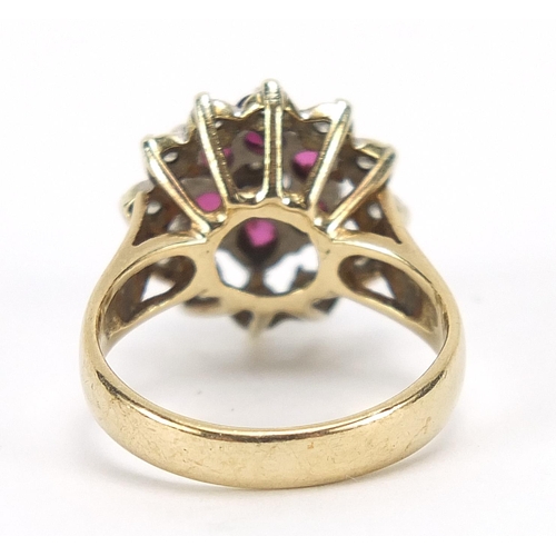 627 - 9ct gold ruby and diamond three tier cluster ring, size K, 4.5g