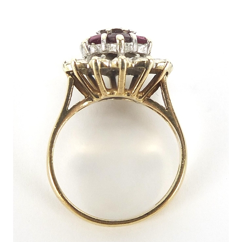 627 - 9ct gold ruby and diamond three tier cluster ring, size K, 4.5g