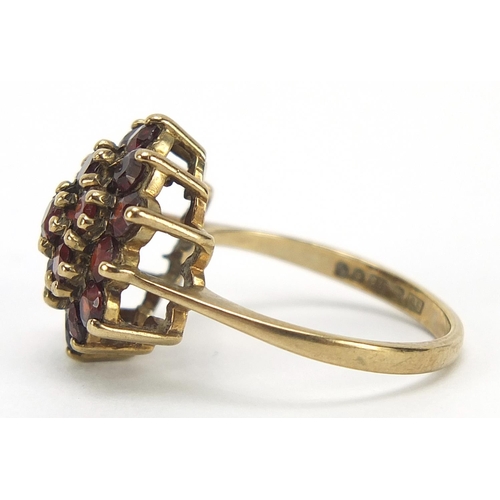 563 - 9ct gold garnet three tier cluster ring, size M, 3.6g