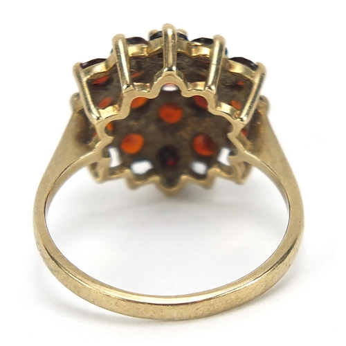 563 - 9ct gold garnet three tier cluster ring, size M, 3.6g