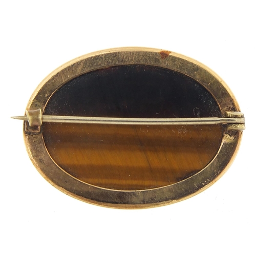 732 - Cabochon tiger's eye brooch with gold coloured metal mount, 3.2cm wide, 7.7g