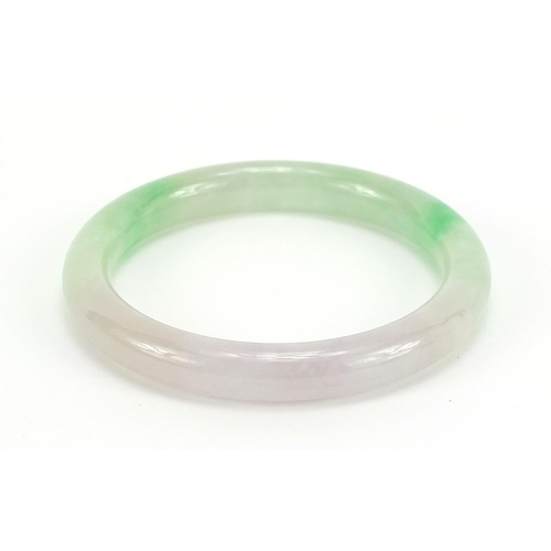 400 - Chinese green and white jade bangle, 7.2cm in diameter, 40.5g