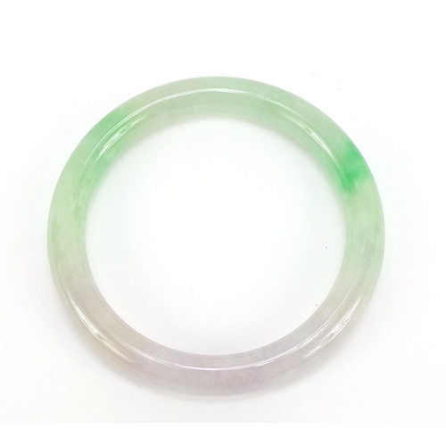 400 - Chinese green and white jade bangle, 7.2cm in diameter, 40.5g