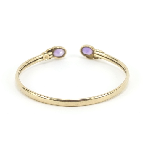 180 - 9ct gold amethyst bangle, 5.5cm in diameter, 6.4g