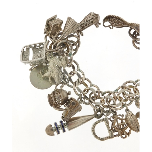 526 - Silver charm bracelet with large selection of mostly silver charms including bust of William Shakesp... 