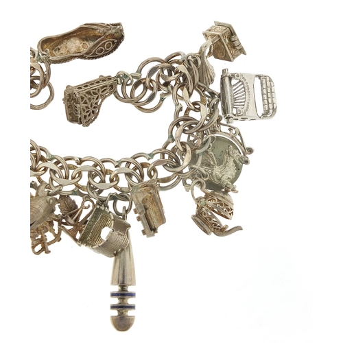 526 - Silver charm bracelet with large selection of mostly silver charms including bust of William Shakesp... 