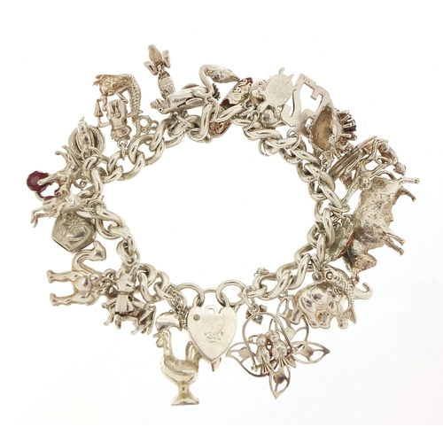 491 - Silver charm bracelet with a selection of mostly silver animal charms including bull, elephant, croc... 