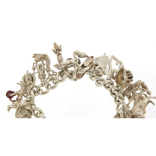 491 - Silver charm bracelet with a selection of mostly silver animal charms including bull, elephant, croc... 