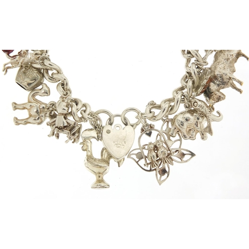 491 - Silver charm bracelet with a selection of mostly silver animal charms including bull, elephant, croc... 