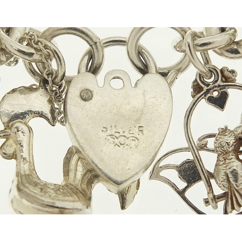 491 - Silver charm bracelet with a selection of mostly silver animal charms including bull, elephant, croc... 