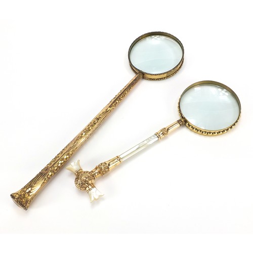 27 - Two large antique gilt metal magnifying glasses including one with mother of pearl handles, the larg... 