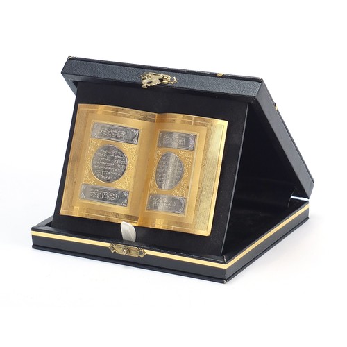 2098 - Islamic gilt and silvered metal book design plaque with case, 10cm wide