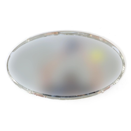 1042 - Art Deco oval wall hanging mirror with bevelled glass and chromed mounts, 60cm x 35cm