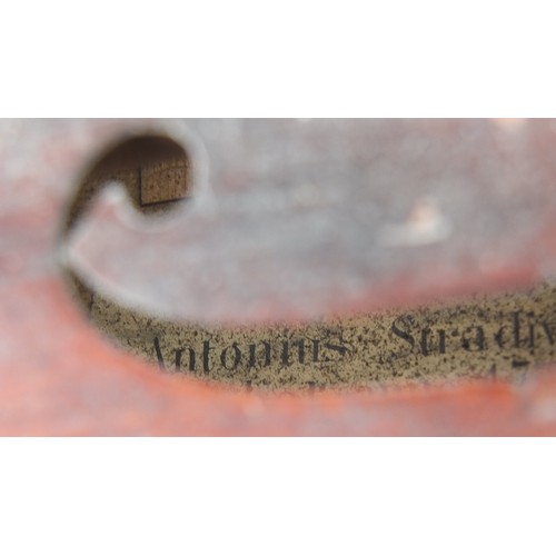 843 - Old wooden violin bearing an Antonius Stradivarius paper label, the violin back 11.75 inches in leng... 