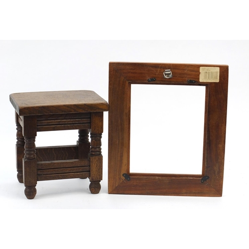 1610 - Carved oak stool and photo frame, the stool 25cm high